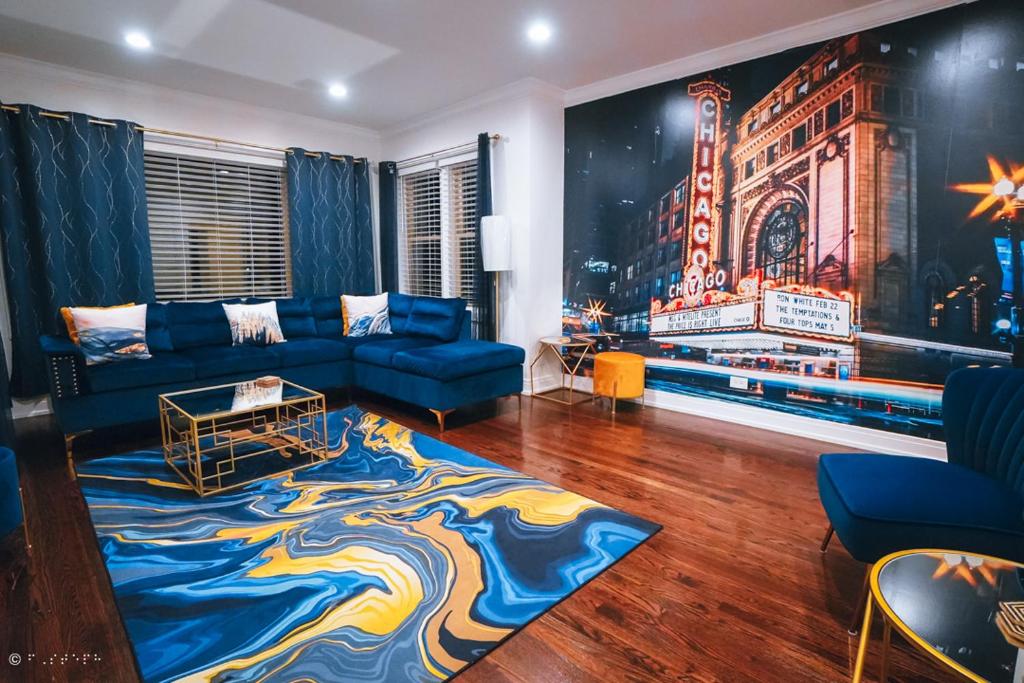 a living room with a blue couch and a painting at The Blue Golden Luxury Modern 3- Bedroom Apartment in Chicago in Chicago