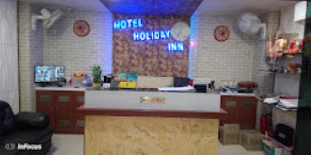 a kitchen with a counter in a restaurant at Hotel Holiday inn , Kanakpur in Silchar