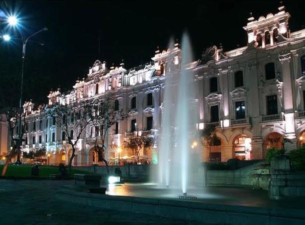 un bâtiment avec une fontaine devant lui la nuit dans l'établissement Duplex in historical heart of the Plaza San Martín, à Lima