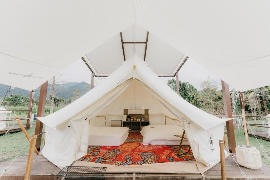 a tent with a bed and a table in it at The Silence Manor in Ruisui