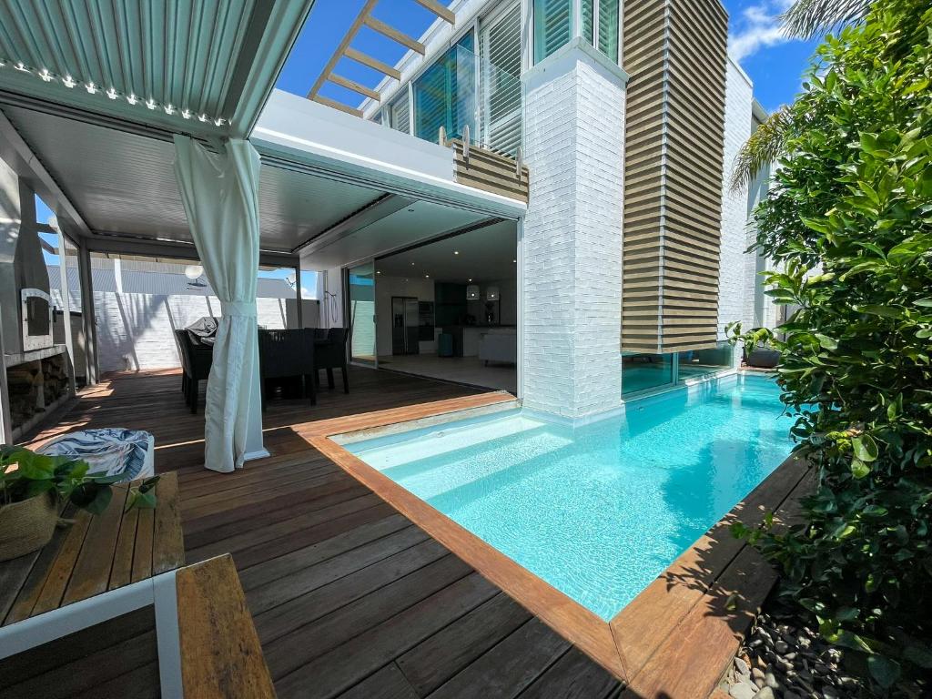 a swimming pool in the middle of a house at Luxury Beachside Retreat in Papamoa