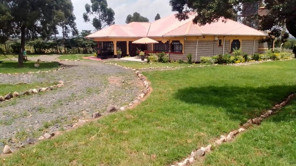 una casa con un gran patio delante de ella en Esniko Villa, en Narok
