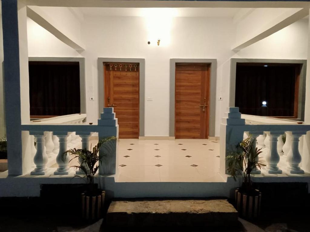 a room with two doors and two potted plants at Patli Fort Hills Estate in Kota Bāgh