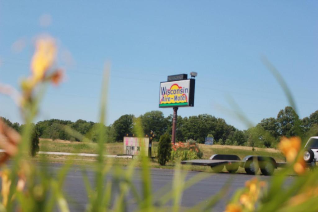 a sign for a fast food restaurant on a road at Wisconsin Aire Motel in Random Lake