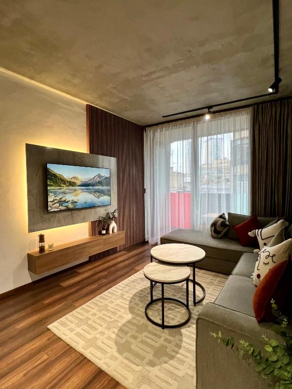 a living room with a couch and a table at Appartement neuf 2 chambres avec salle de sport in Casablanca