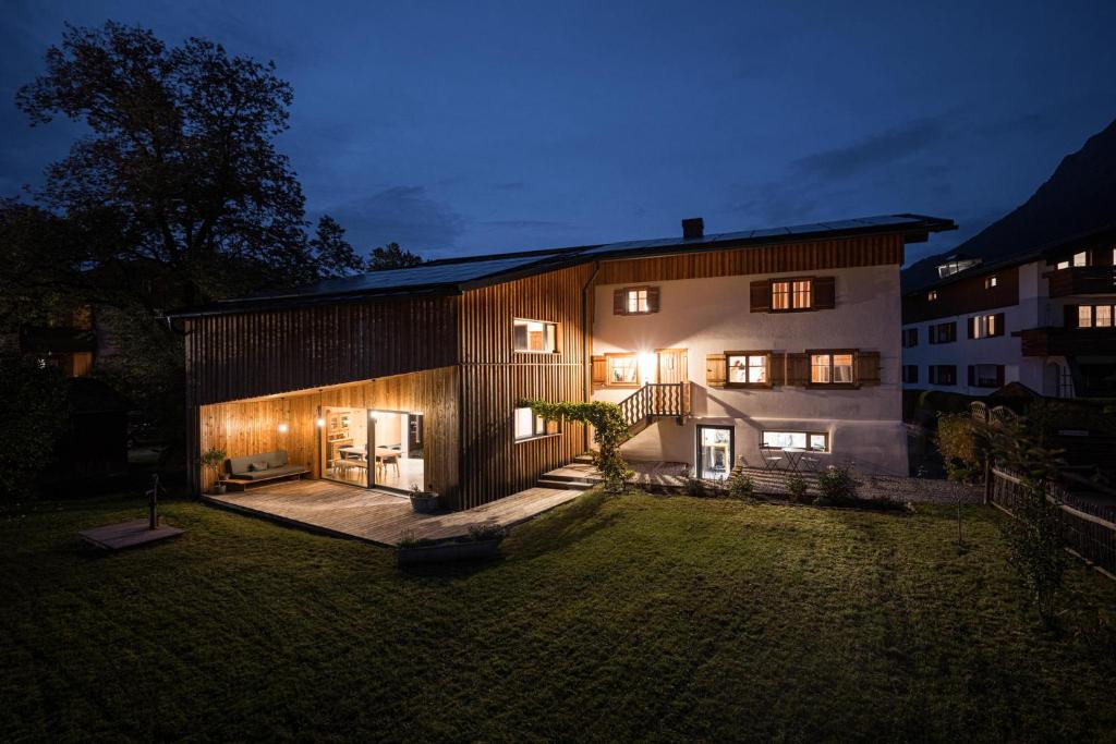 a house with lights on the side of it at night at Ferienwohnung Lexar Hüs Oberstdorf in Oberstdorf