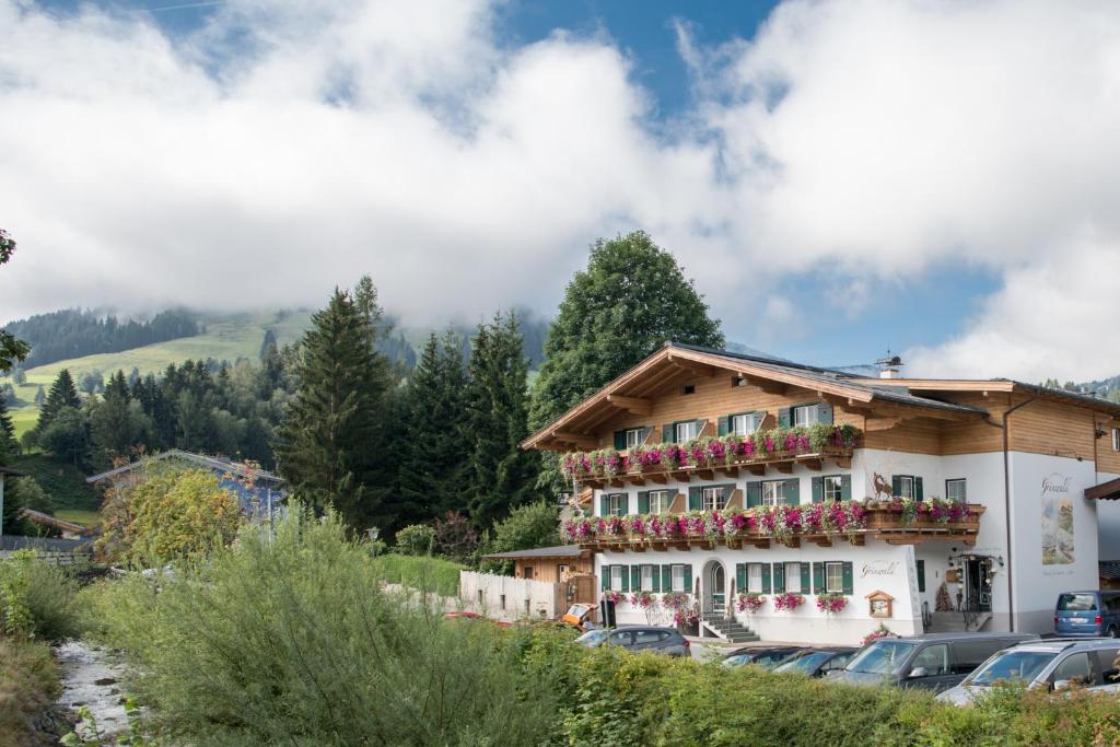 a building with flowers on the side of it at Gourmet-Hotel Grünwald in Leogang