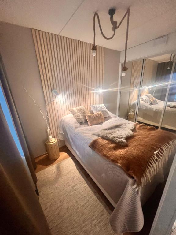 a bedroom with a bed with a brown blanket at 2 Room / Central Railway / Free parking in Seinäjoki