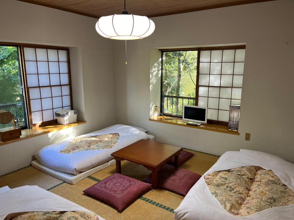 Postel nebo postele na pokoji v ubytování Fuji-Hakone Guest House
