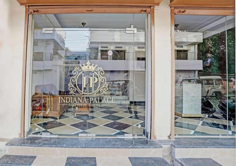 a window of a furniture store with a sign in it at Hotel Indiana Palace in Kānpur