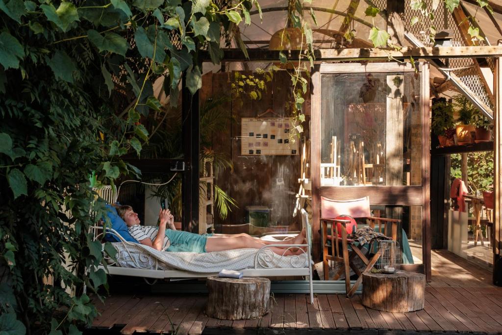 a man laying in a bed in a play house at Maceda Surf Camp in Maceda