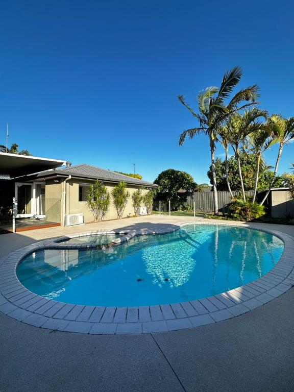 a swimming pool in the middle of a house at Tranquil Scape-Villa with Pool by Gold Coast Premium in Gold Coast