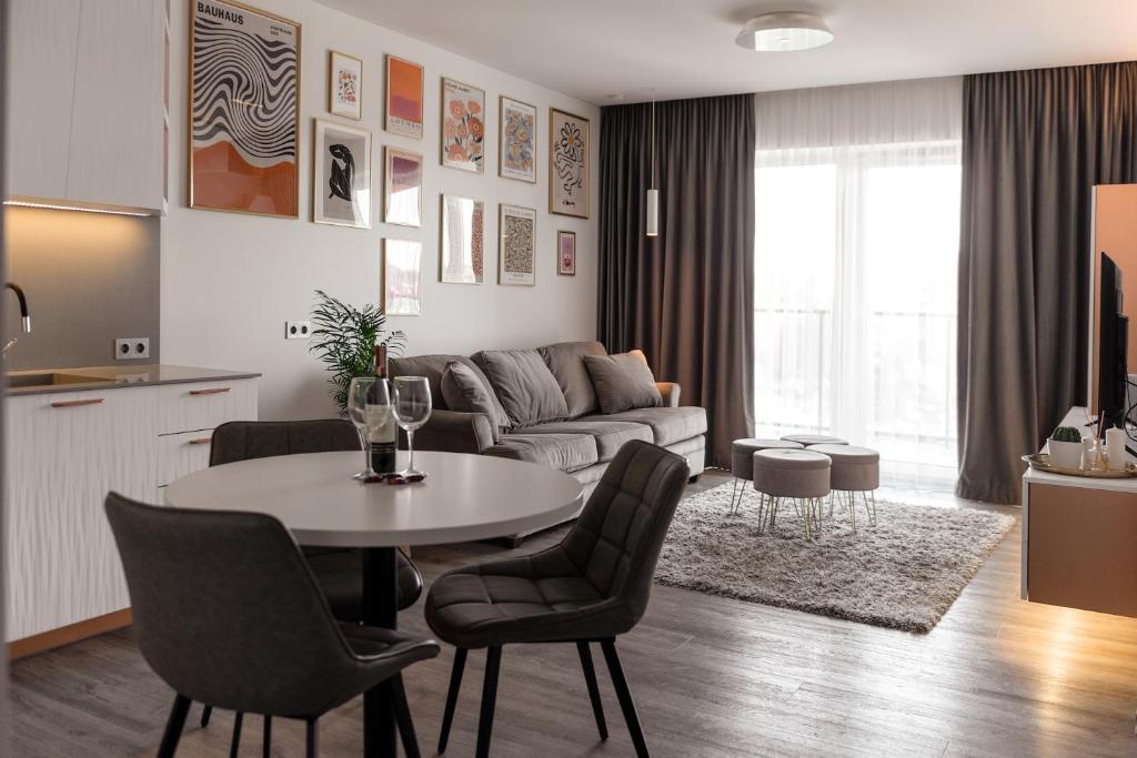 a living room with a table and a couch at Bright Kaunas apartment with Castle view in Kaunas
