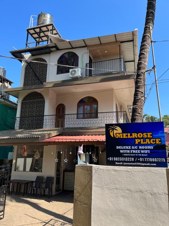 a building with a sign in front of it at Melrose Place Goa in Calangute