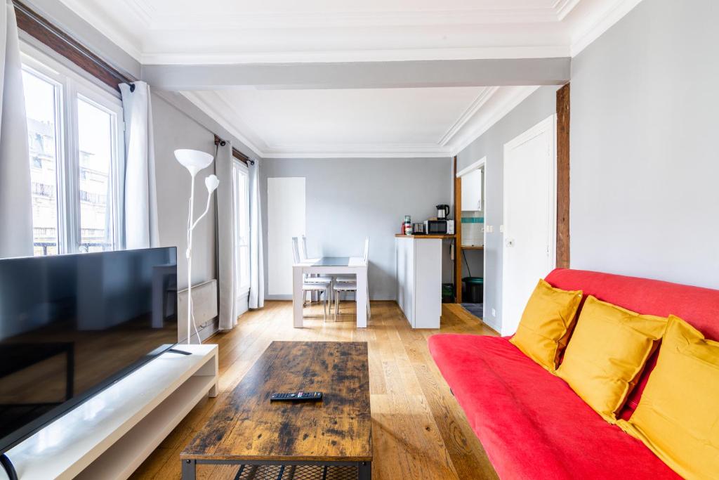 een woonkamer met een bank en een tafel bij Luxurious 2 Bedroom Tour Eiffel Bourdonnais Free Netflix in Parijs