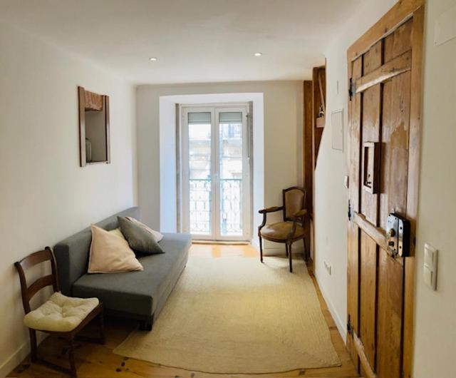 a living room with a couch and a window at Heart of Lisbon Apartment in Lisbon