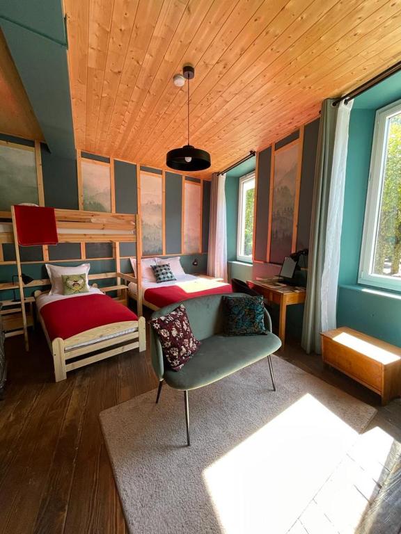 a bedroom with two bunk beds and a chair at Eau Berges in Vicdessos