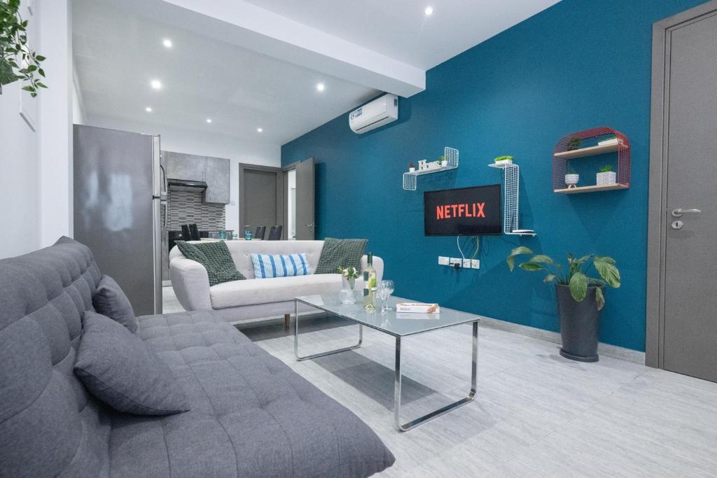 a living room with a couch and a table at Bellagio Napa Suites in Ayia Napa