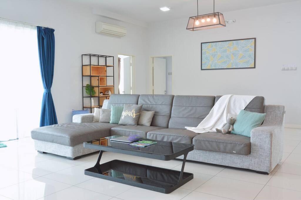 a living room with a couch and a coffee table at 2000sq ft 186平米Luxury Residence in IMAGO Mall, KK in Kota Kinabalu