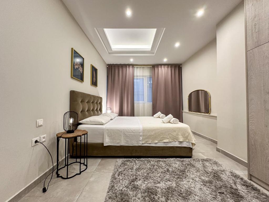 a bedroom with a large bed and a rug at Contemporary & Spacious Renovated Apartment, DT Syntagma, /Touristic Area in Athens