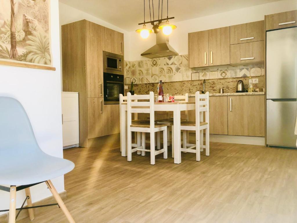 una cucina con tavolo bianco e sedie bianche di Apartment Alegria in Mozaga a Mozaga