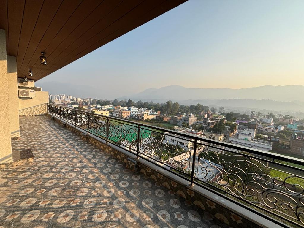 a balcony with a view of a city at 4 BHK Mountain View Villa In Rishikesh in Rishīkesh