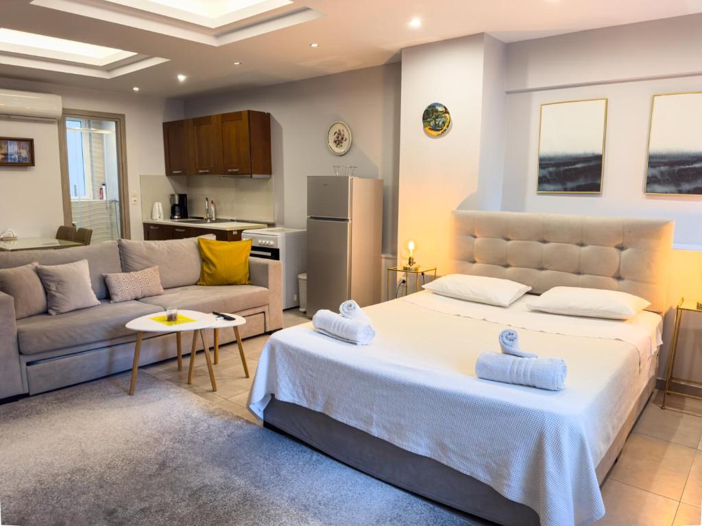 a bedroom with a large bed and a couch at Glamorous & Spacious Renovated Apartment, Syntagma, DT Athens in Athens