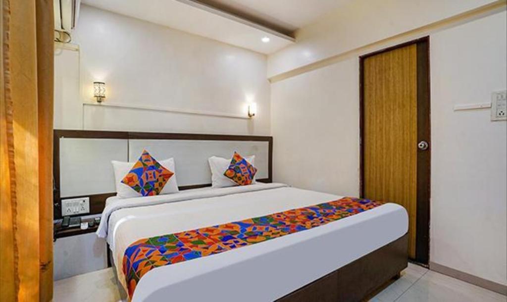 a bedroom with a large bed in a room at FabExpress Prabhu Sharan in Mumbai
