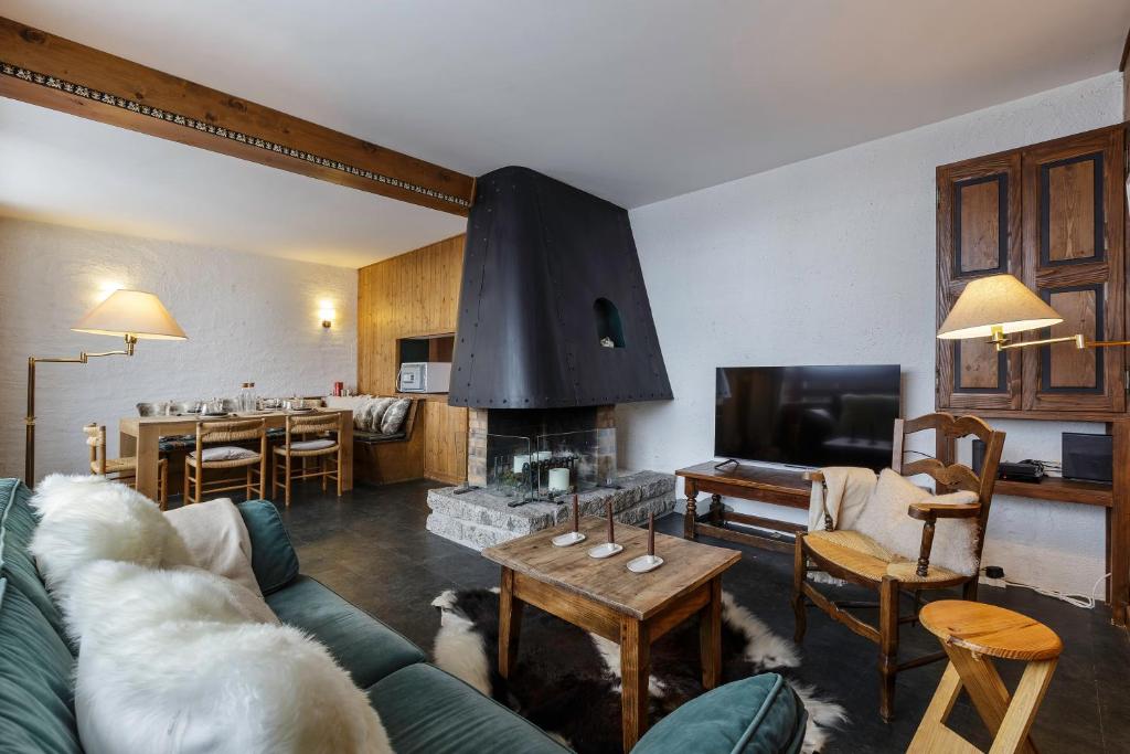 a living room with a couch and a fireplace at Sunny Nest - View Of MB Montroc - Happy Rentals in Chamonix