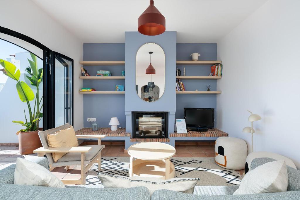 a living room with a couch and a fireplace at Vila Ramalhete W/ 3 BDR & Balcony by LovelyStay in Altura