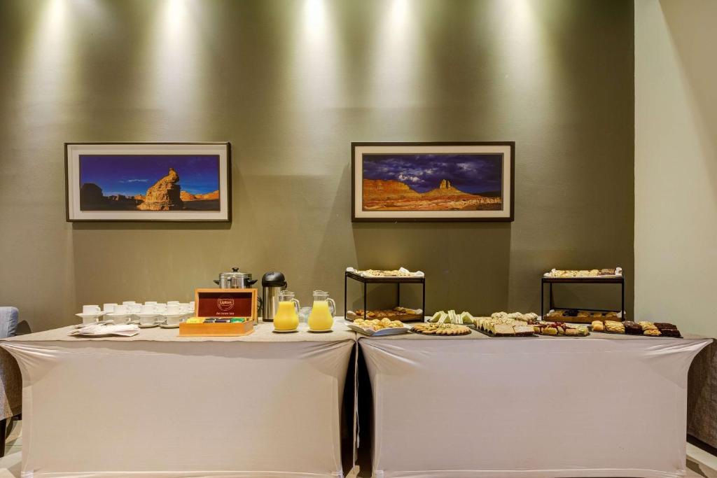 a table with food on top of it at La Quinta by Wyndham Santiago Aeropuerto in Santiago