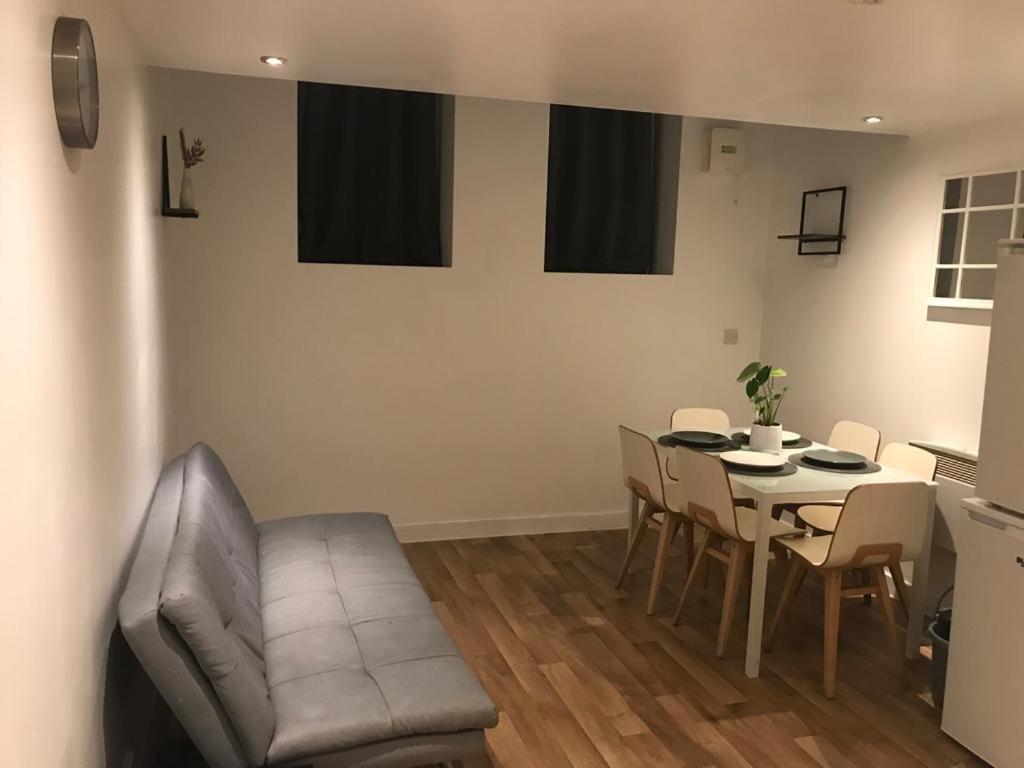 a living room with a table and chairs and a couch at Lovely Cozy One bedroom close to city centre Liverpool in Liverpool