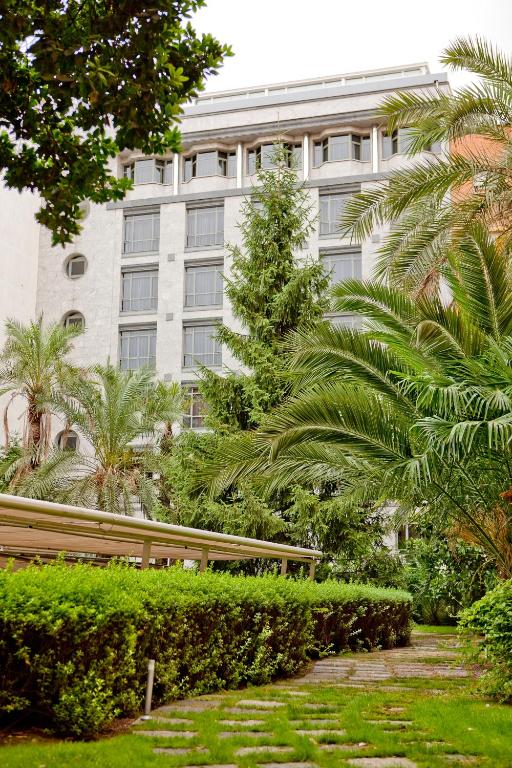 a building with palm trees in front of it at VP Madroño in Madrid