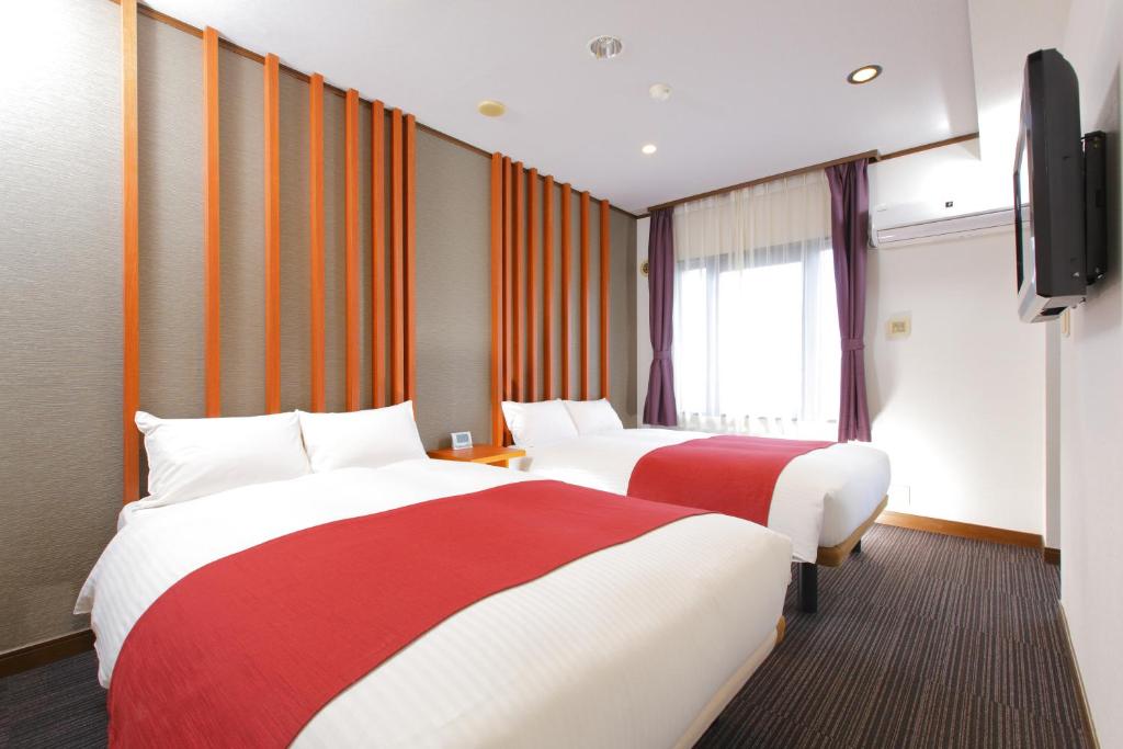 Postel nebo postele na pokoji v ubytování HOTEL MYSTAYS Kameido