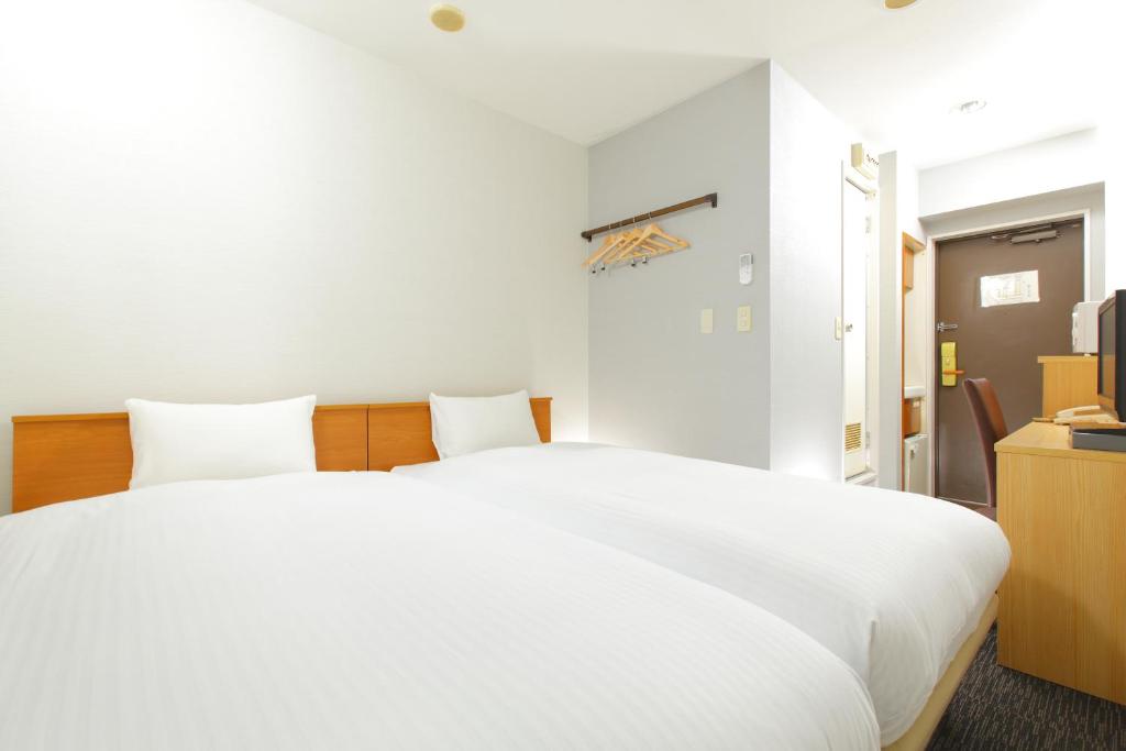 Postel nebo postele na pokoji v ubytování HOTEL MYSTAYS Kameido