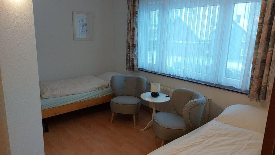 a room with a bed and a couch and a table at Pension Britta in Roetgen
