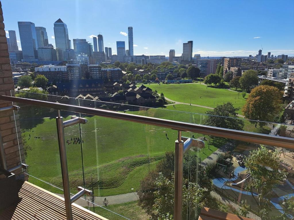 a view of a park with a city in the background at Cozy Double Room with Large En Suite Near Canary Wharf London with Amazing Views in a Shared Apartment in London