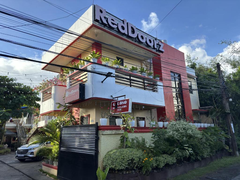 a building with a sign on the side of it at RedDoorz near Mariners Legazpi in Legazpi