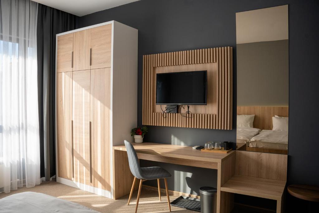 TV a/nebo společenská místnost v ubytování Olivia Rooms