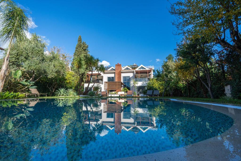 a house with a swimming pool in front of a house at HEART DE MAISON in Kemer