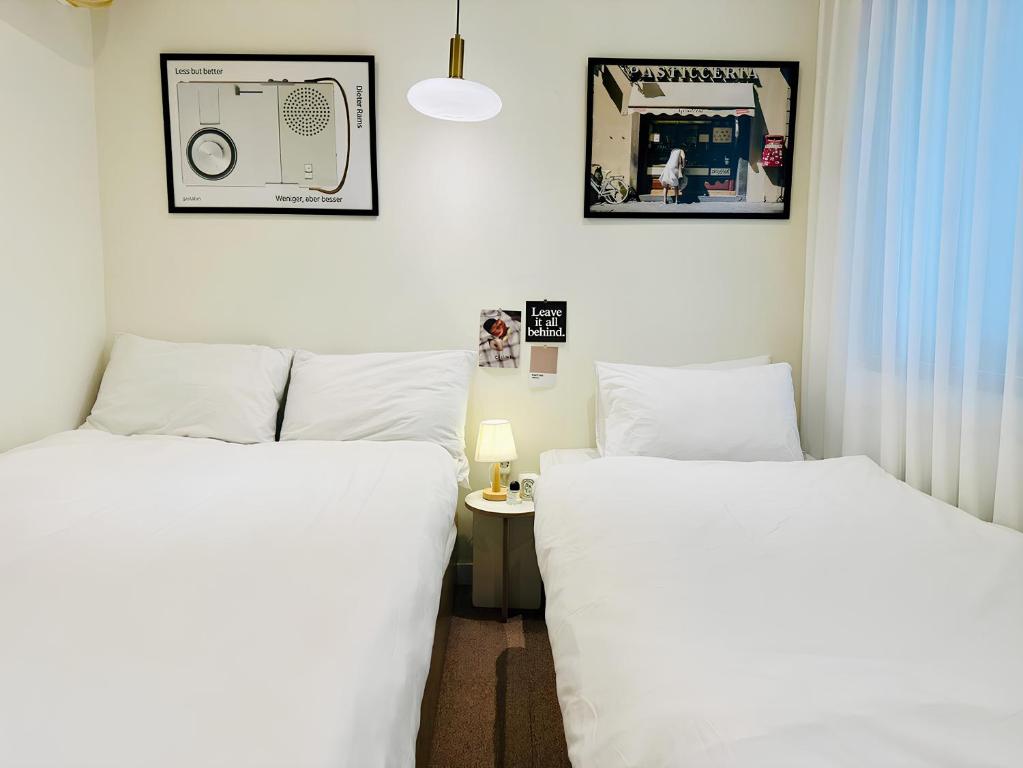 Postel nebo postele na pokoji v ubytování SSH Ikseon peter cat Hostel