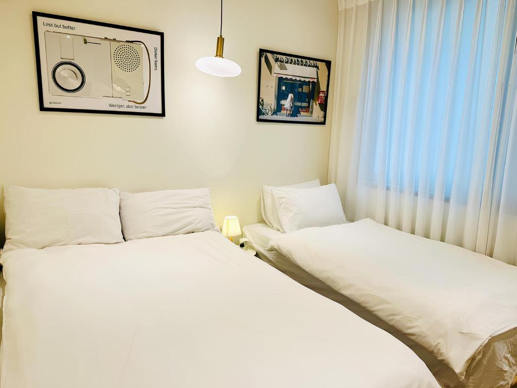 Postel nebo postele na pokoji v ubytování SSH Ikseon peter cat Hostel