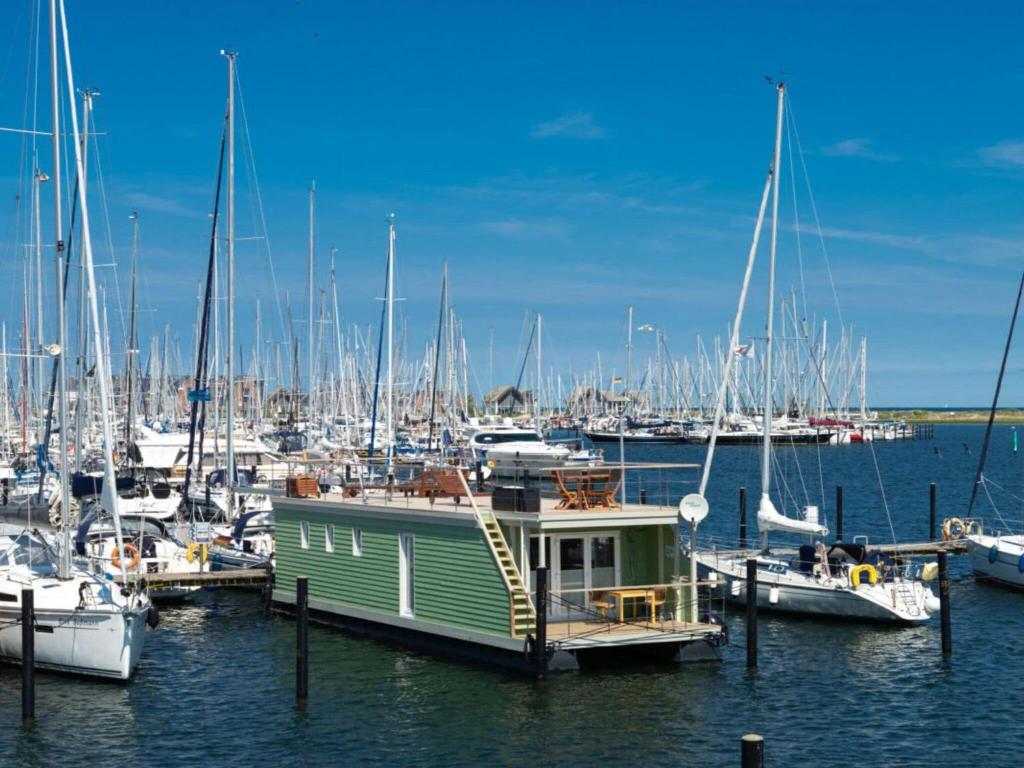 a boat docked in a marina with other boats at Houseboat gray seal in Heiligenhafen