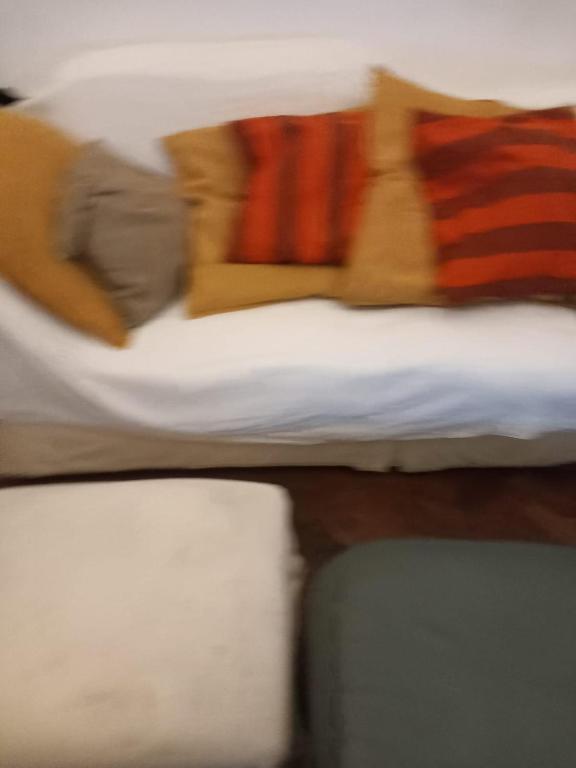 a blurry picture of a bed with colorful pillows at Rochester Corner in Rochester