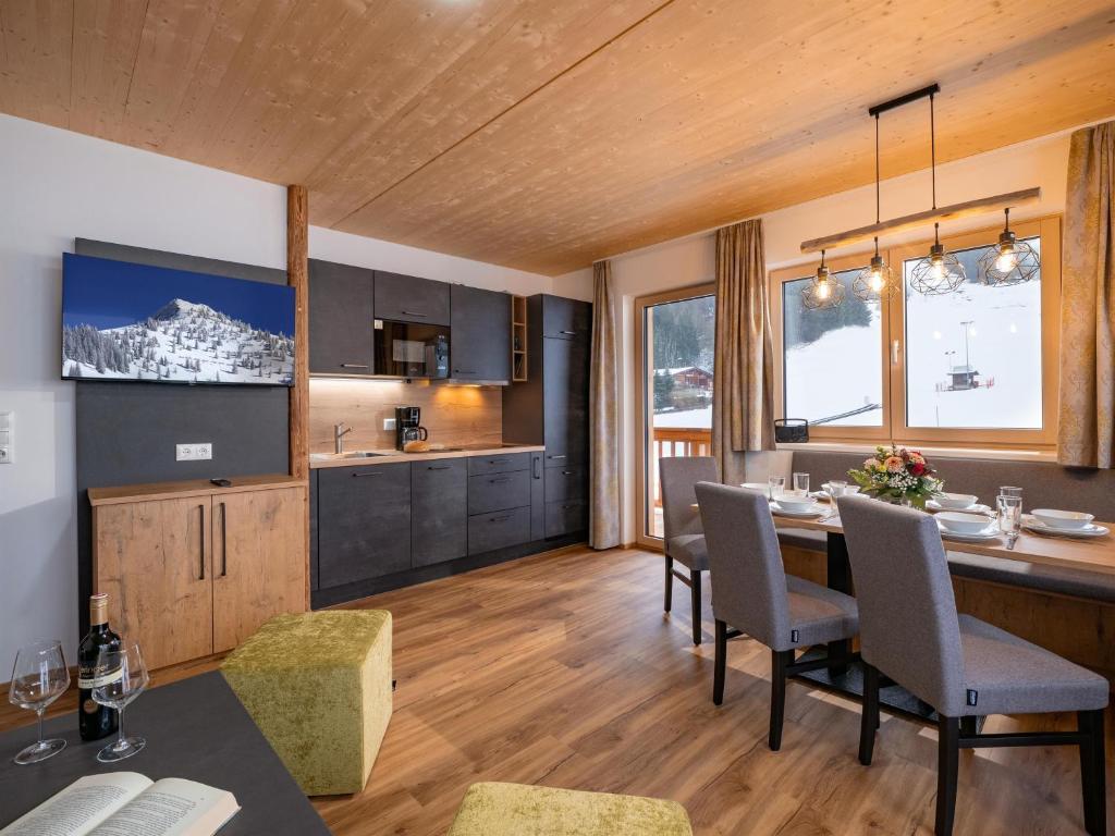 a kitchen and dining room with a table and chairs at M&M Appartements Brixental in Westendorf