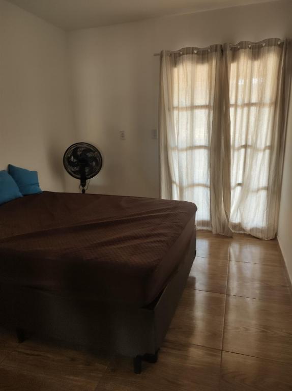 a bedroom with a bed and a large window at Casa Mar Azul in Pitimbu