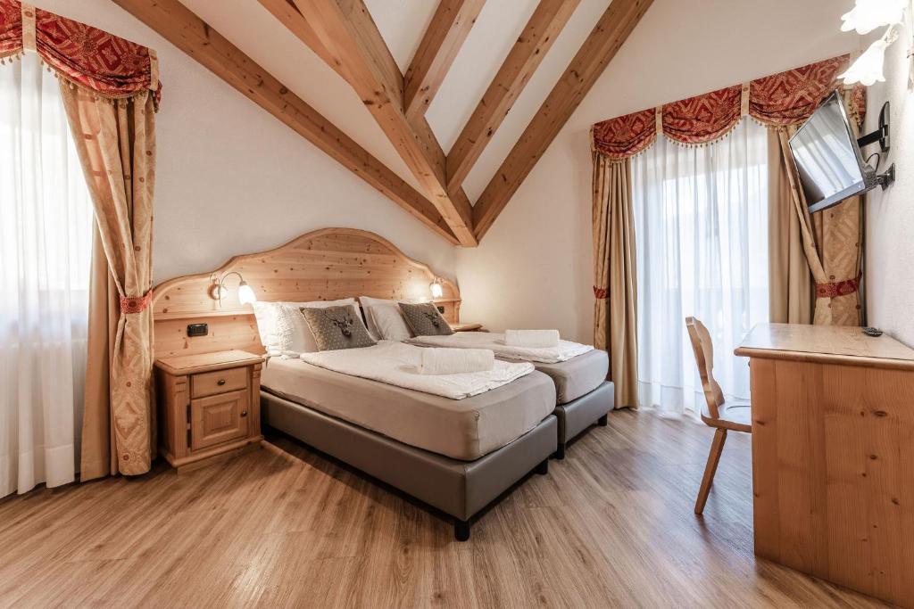 Postel nebo postele na pokoji v ubytování Hotel Sasso Rosso
