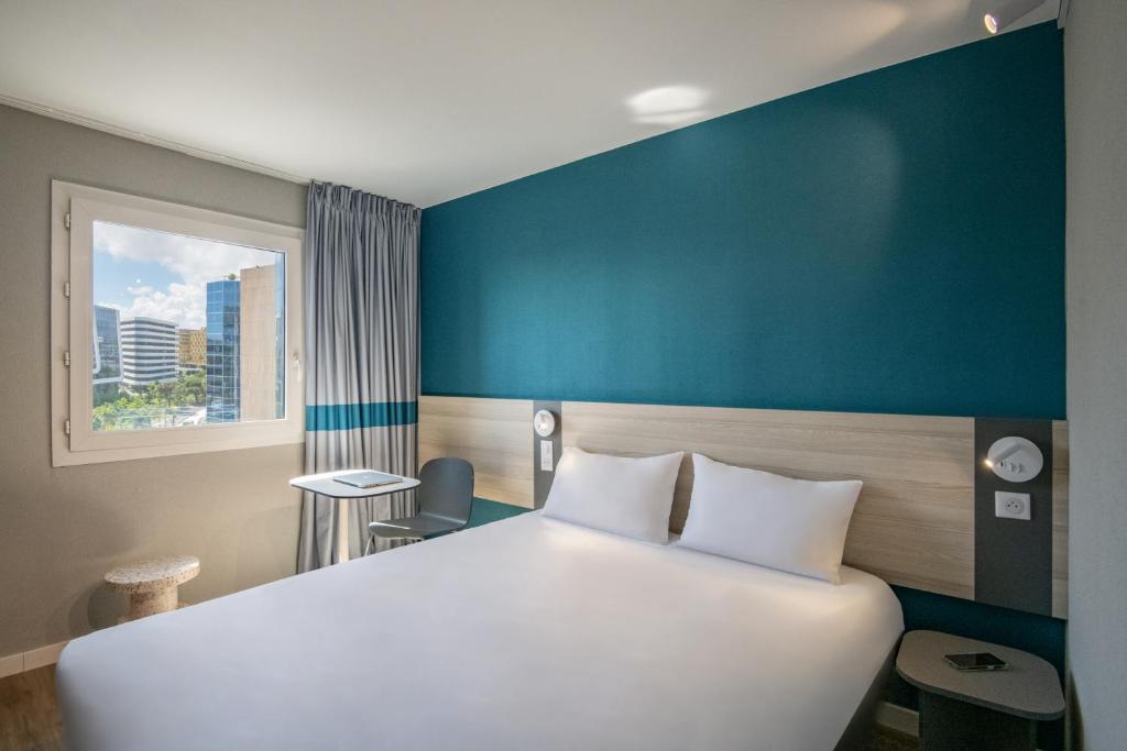 Postel nebo postele na pokoji v ubytování ibis budget Nice Aeroport