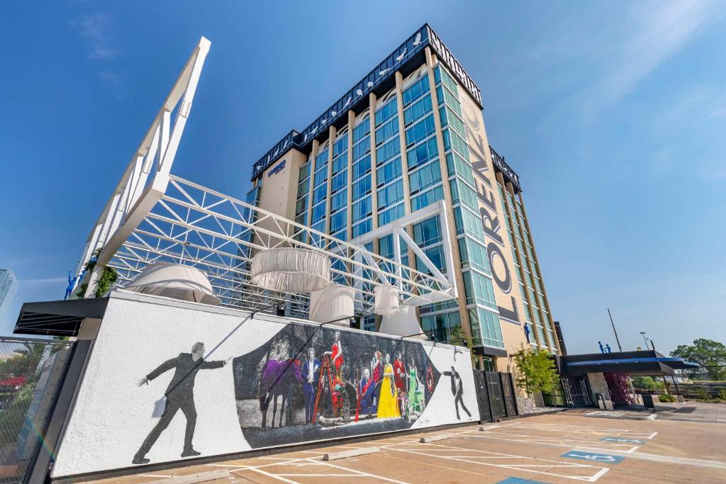 a building with a mural of a man on it at Lorenzo Hotel Dallas, Tapestry Collection by Hilton in Dallas