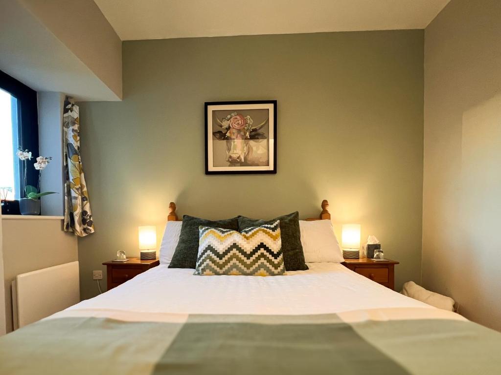 1 dormitorio con 1 cama grande y 2 lámparas en Buttermilk Walk Room en Galway